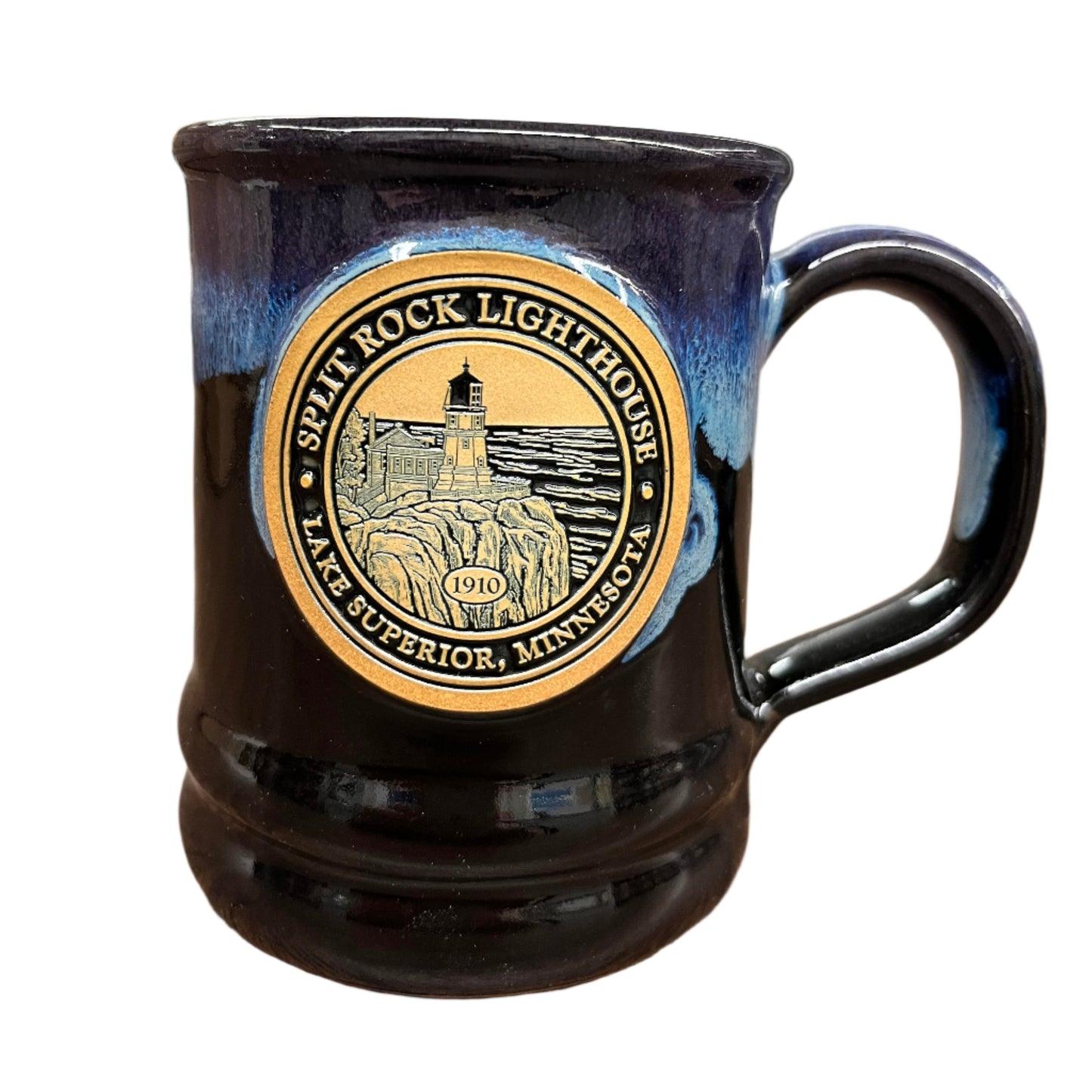 The Split Rock Lighthouse Ramsey Mug by Deneen Pottery features a gold and black emblem of the historic 1910 Lake Superior lighthouse, finished with a blue and black glaze.